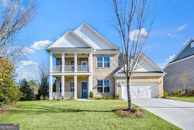 neoclassical / greek revival house featuring a balcony, covered porch, a front yard, and a garage