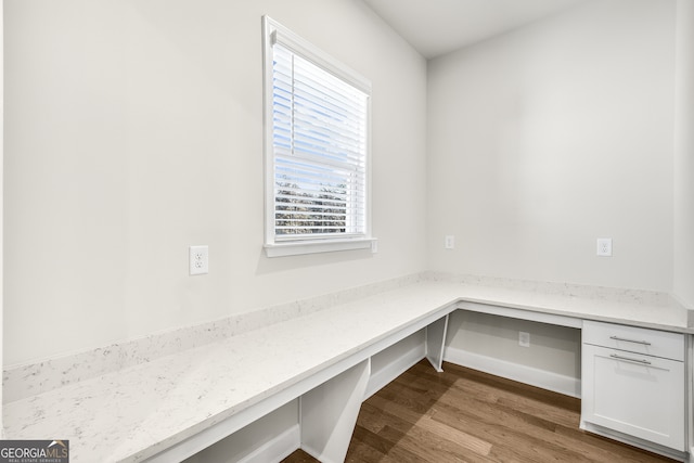 mudroom featuring built in desk and light hardwood / wood-style flooring