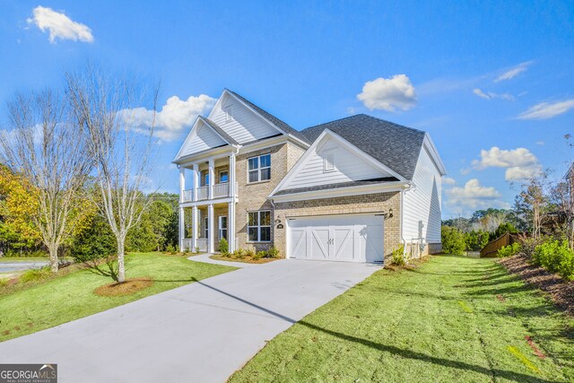 view of front of property with a balcony and a front lawn