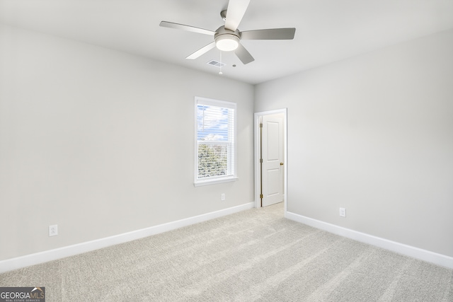 empty room featuring light carpet and ceiling fan