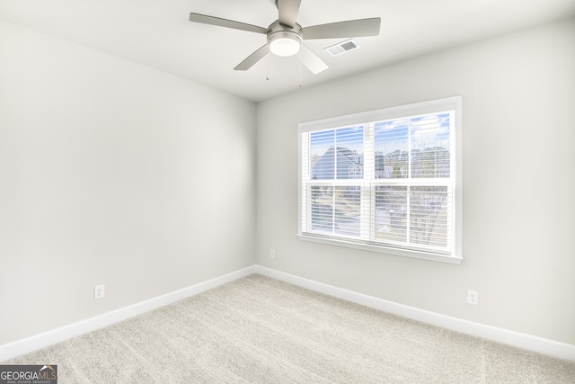 empty room featuring carpet flooring and ceiling fan