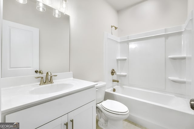 full bathroom featuring washtub / shower combination, vanity, and toilet