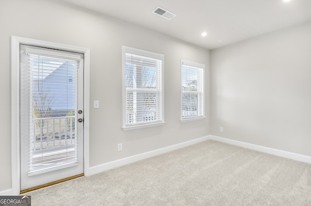 doorway with carpet flooring and a healthy amount of sunlight