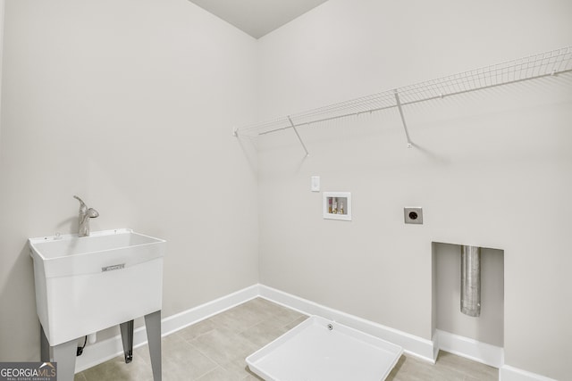 clothes washing area featuring sink, hookup for a washing machine, light tile patterned flooring, and hookup for an electric dryer