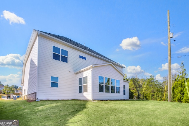 rear view of house with a lawn