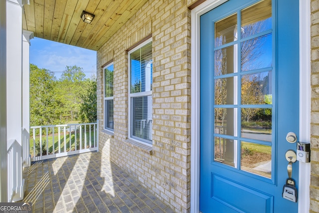 doorway to property featuring covered porch