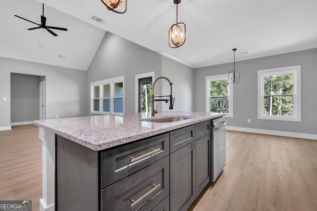 417 Lakeview Pl, Macon, GA 31211 - kitchen featuring a sink, light wood-type flooring, dishwasher, hanging light fixtures, and light stone counters