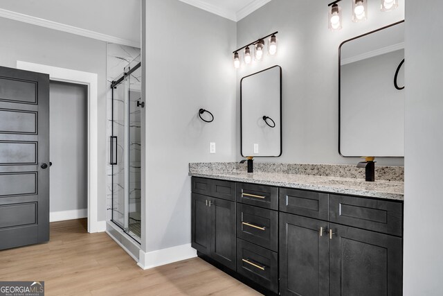 417 Lakeview Pl, Macon, GA 31211 - bathroom featuring ornamental molding, a stall shower, wood finished floors, baseboards, and double vanity