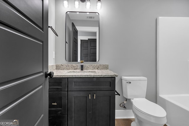 417 Lakeview Pl, Macon, GA 31211 - full bath featuring toilet, vanity, a bathtub, and wood finished floors
