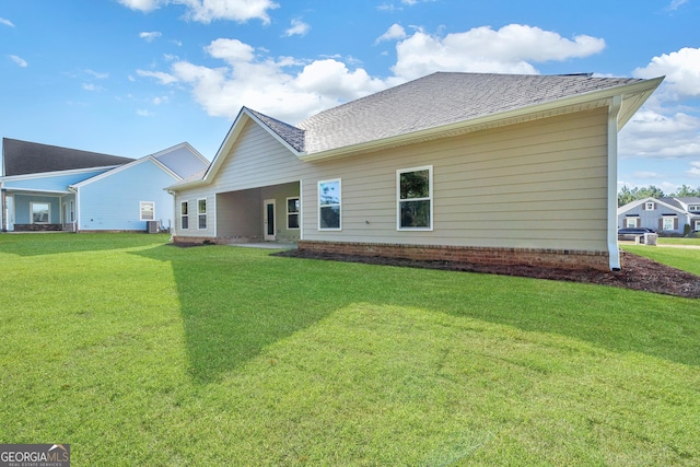 417 Lakeview Pl, Macon, GA 31211 - back of house featuring a yard, central AC unit, and roof with shingles