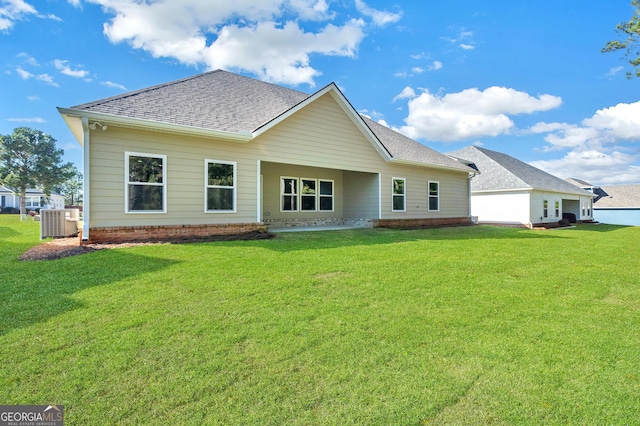 417 Lakeview Pl, Macon, GA 31211 - back of property with a shingled roof, central air condition unit, and a lawn