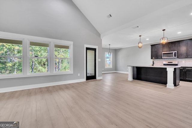 417 Lakeview Pl, Macon, GA 31211 - kitchen featuring stainless steel microwave, open floor plan, electric range, light countertops, and recessed lighting