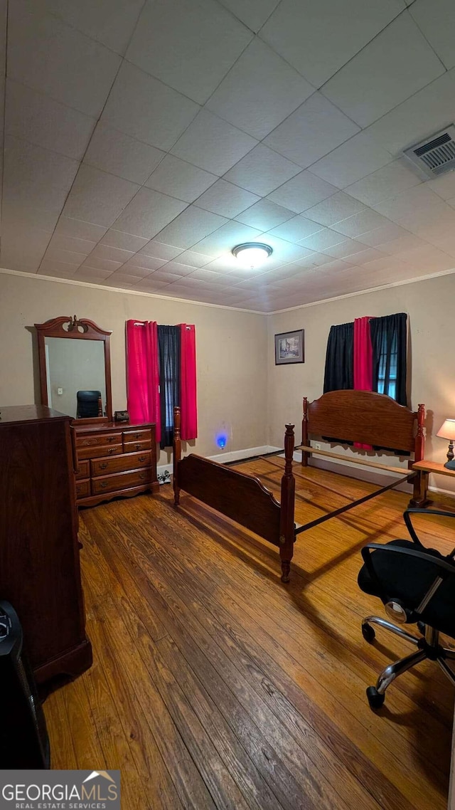 bedroom with hardwood / wood-style flooring