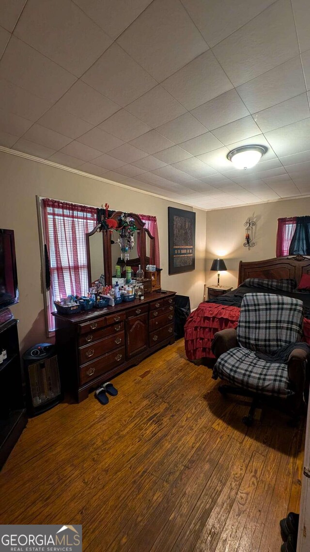 bedroom with wood-type flooring