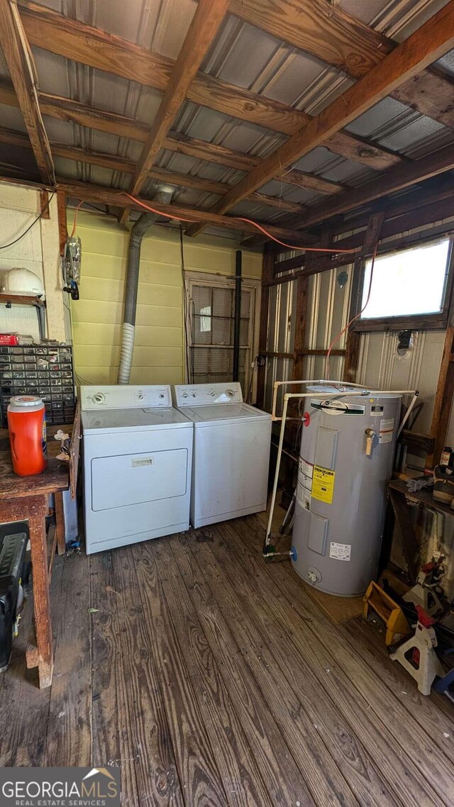 laundry area featuring independent washer and dryer, wood walls, dark hardwood / wood-style flooring, and water heater