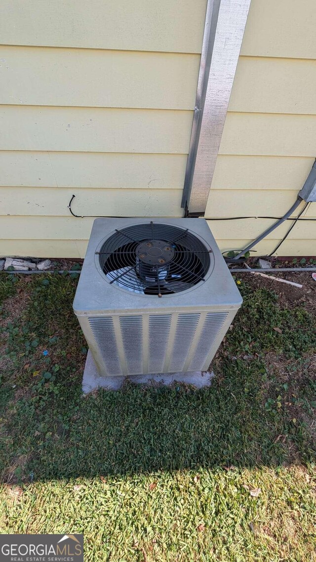 exterior details featuring central air condition unit and wood walls