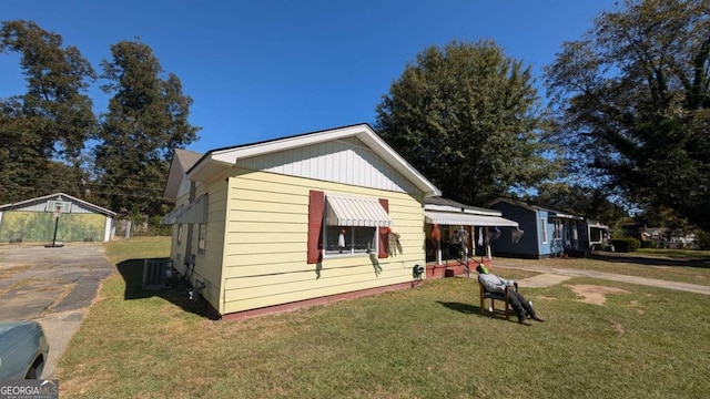 view of front of property with a front yard and an outbuilding