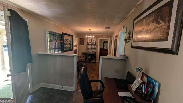 office space featuring a notable chandelier and ornamental molding