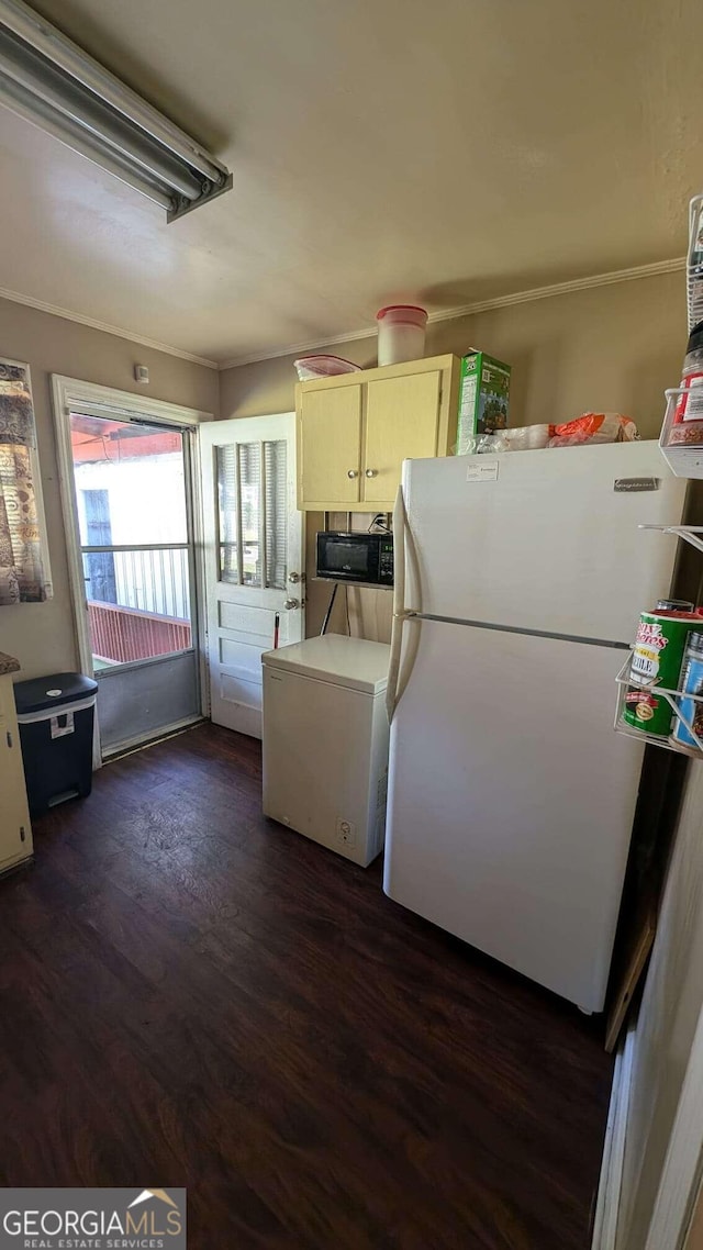 kitchen featuring dark hardwood / wood-style flooring, fridge, and white refrigerator