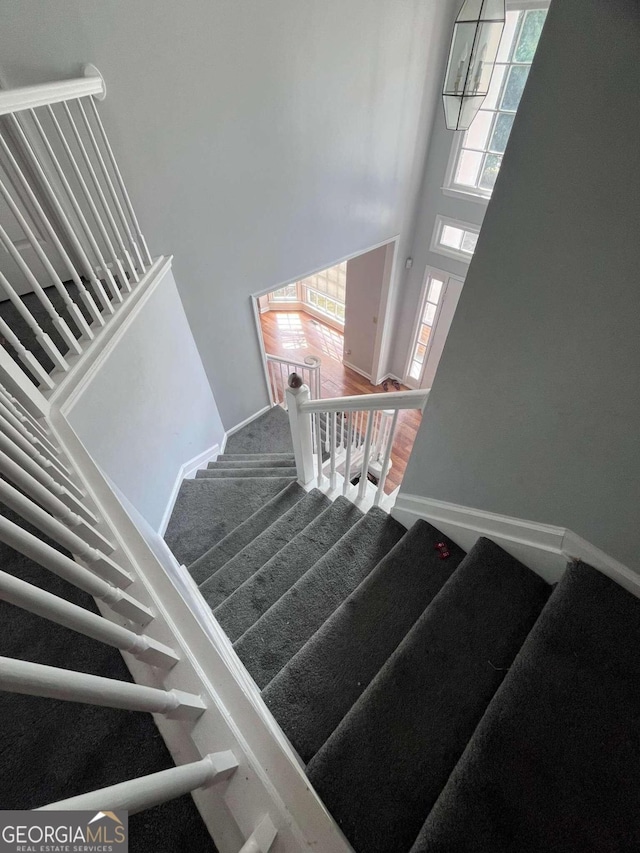 stairs featuring a towering ceiling