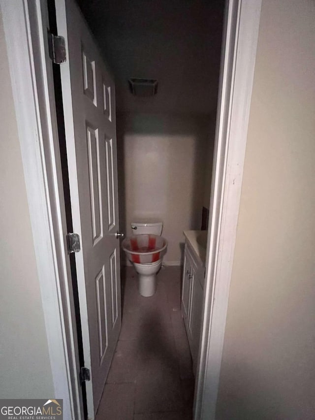 bathroom featuring vanity, toilet, and tile patterned flooring