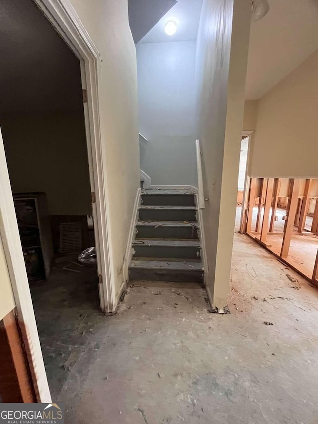 stairs with concrete flooring