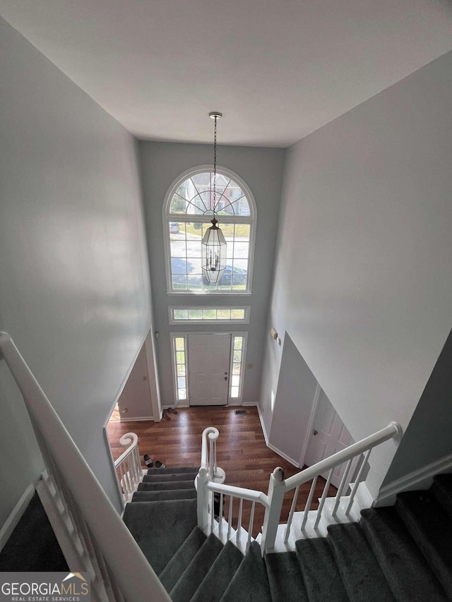 foyer entrance featuring an inviting chandelier and dark hardwood / wood-style floors