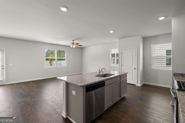 kitchen with sink, dark hardwood / wood-style floors, an island with sink, ceiling fan, and stainless steel appliances