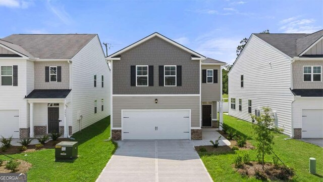 view of front facade featuring a front yard and a garage