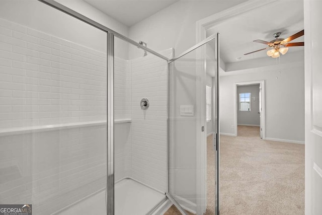 bathroom with ceiling fan and a shower with door