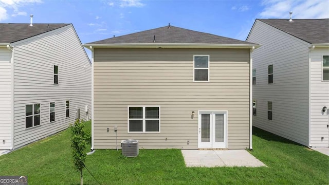 rear view of house with a patio, central AC, and a lawn