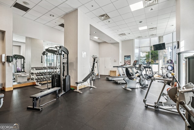 workout area with a high ceiling and a drop ceiling