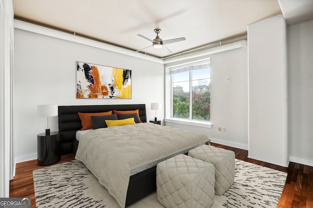 bedroom featuring ceiling fan and dark hardwood / wood-style floors