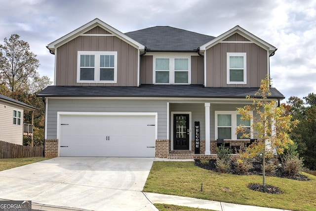 craftsman-style home with covered porch, a garage, and a front lawn