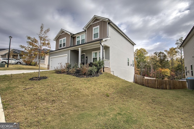 view of front of house featuring central AC unit, covered porch, a front yard, and a garage