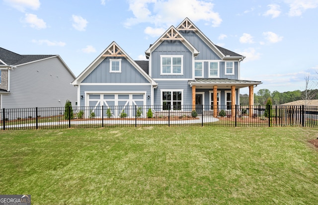 rear view of property with a garage, a lawn, and a porch