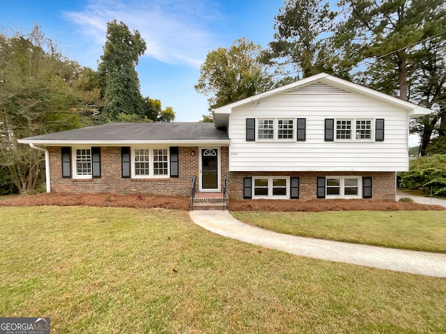 split level home featuring a front lawn