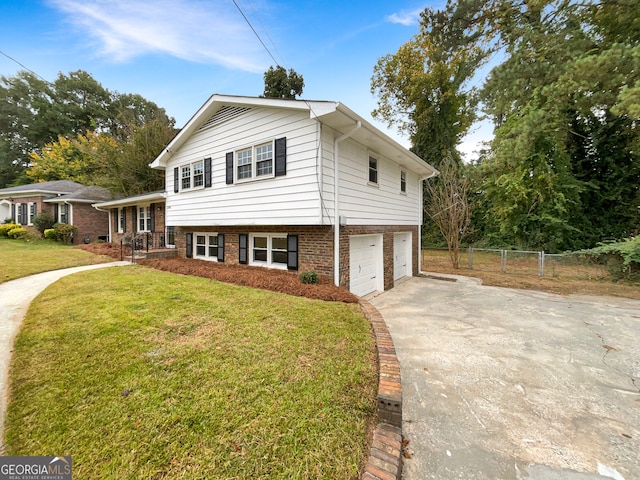 split level home with a front lawn and a garage