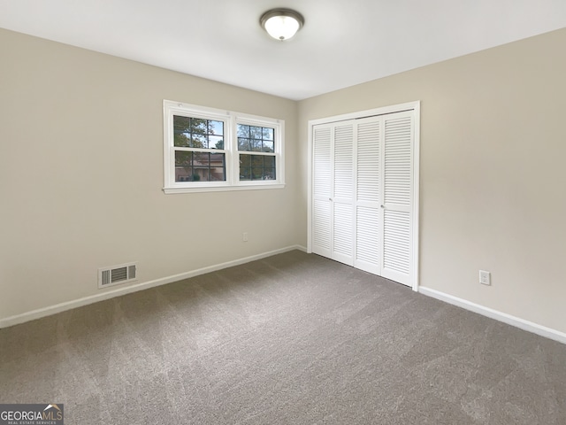 unfurnished bedroom featuring a closet and carpet flooring