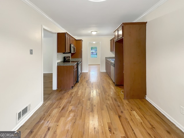 kitchen featuring appliances with stainless steel finishes, light hardwood / wood-style flooring, stone counters, and crown molding