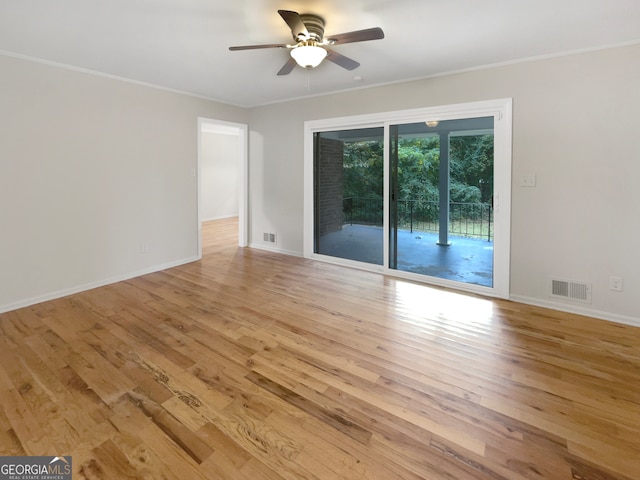 spare room with crown molding, light wood-type flooring, and ceiling fan