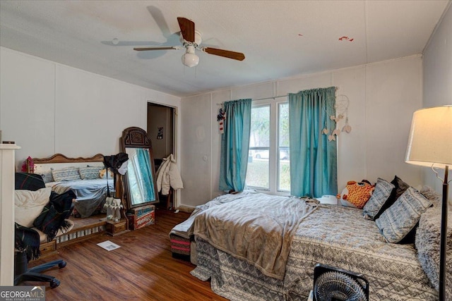 bedroom with ceiling fan and dark hardwood / wood-style flooring