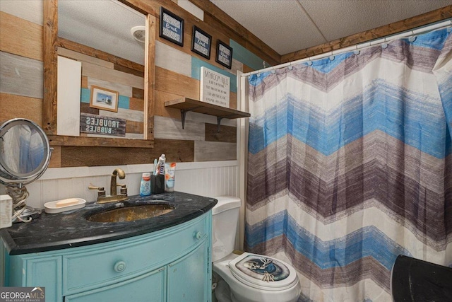 bathroom with walk in shower, vanity, and toilet