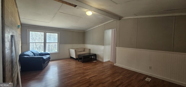 unfurnished room featuring vaulted ceiling with beams and dark wood-type flooring