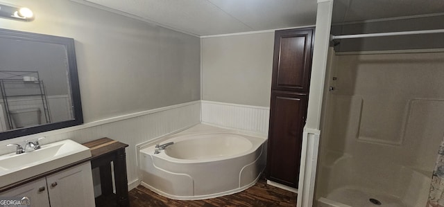 bathroom featuring hardwood / wood-style flooring, vanity, and shower with separate bathtub