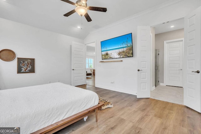 bedroom featuring light hardwood / wood-style floors, ornamental molding, and ceiling fan