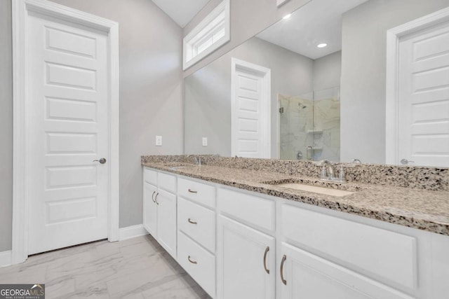 bathroom with vanity and a shower with shower door