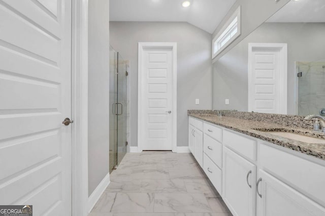 bathroom with vanity, vaulted ceiling, and an enclosed shower