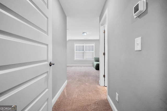 hallway with light colored carpet