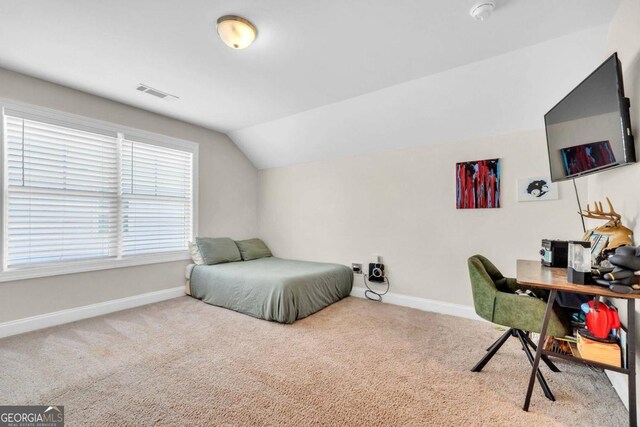 bedroom featuring lofted ceiling and carpet floors